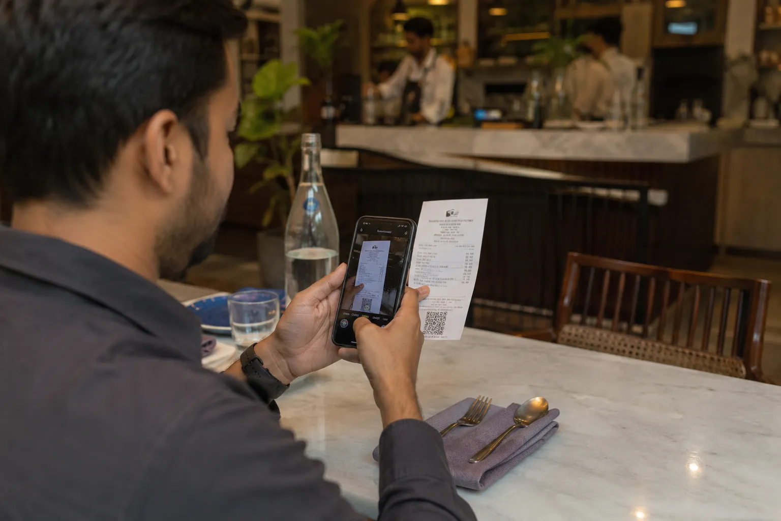employee scanning hotel bill with cloud based expense management software